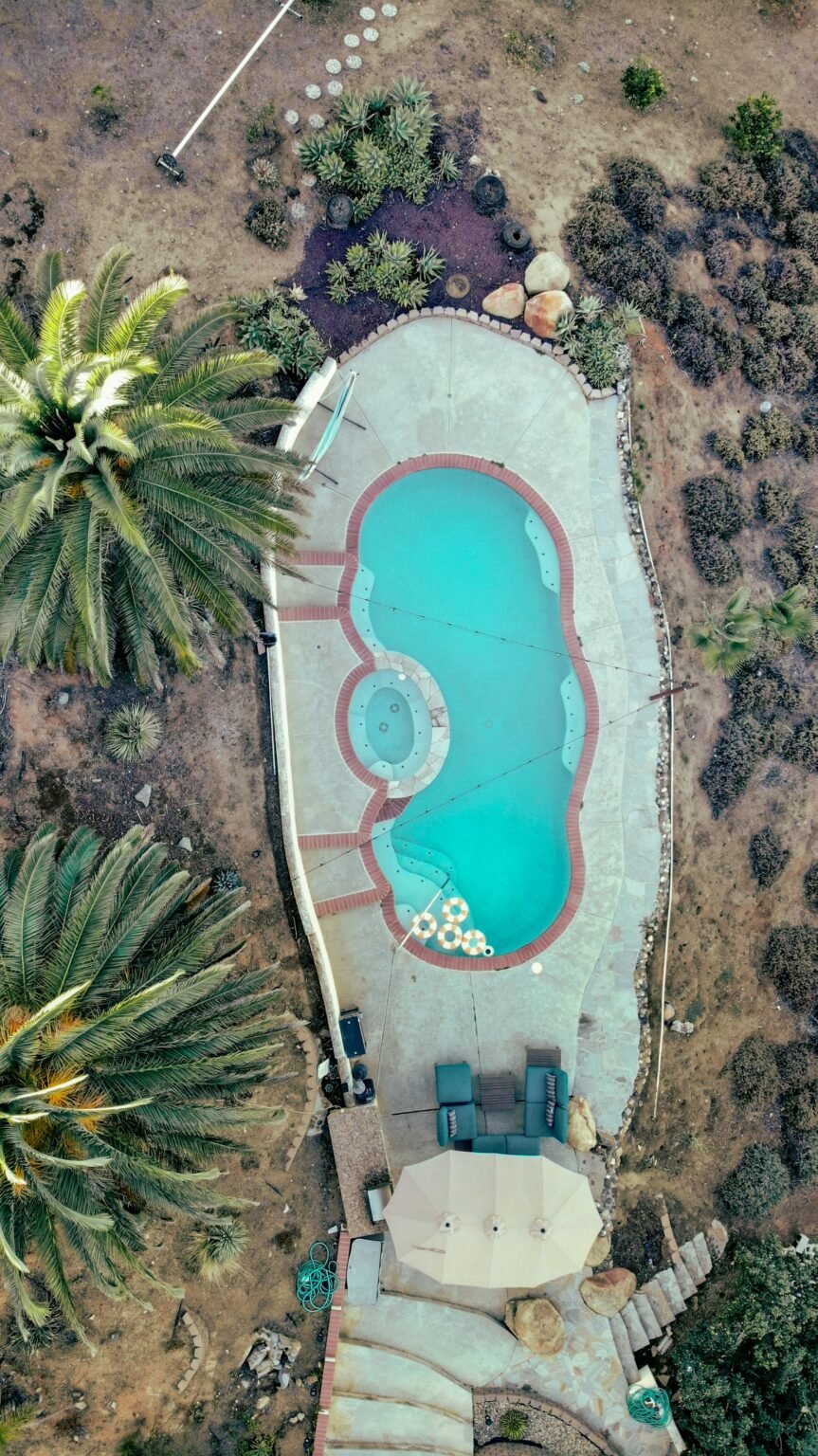 Aerial view of a freeform pool with an attached spa