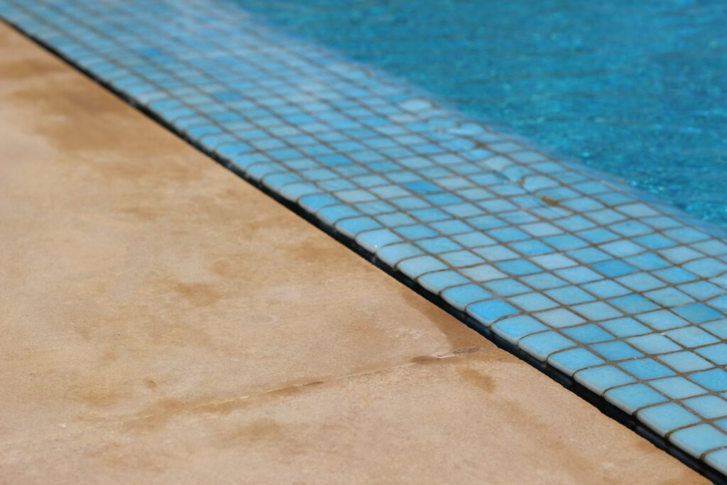 Pool waterline tile and stone coping, an area prone to calcium buildup